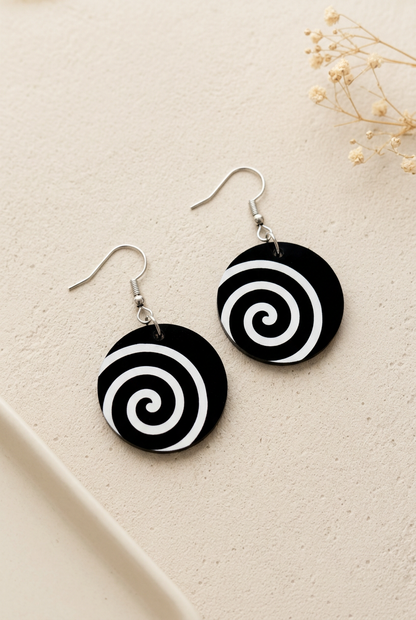 Soft warm product photo of your black and white spiral earrings
