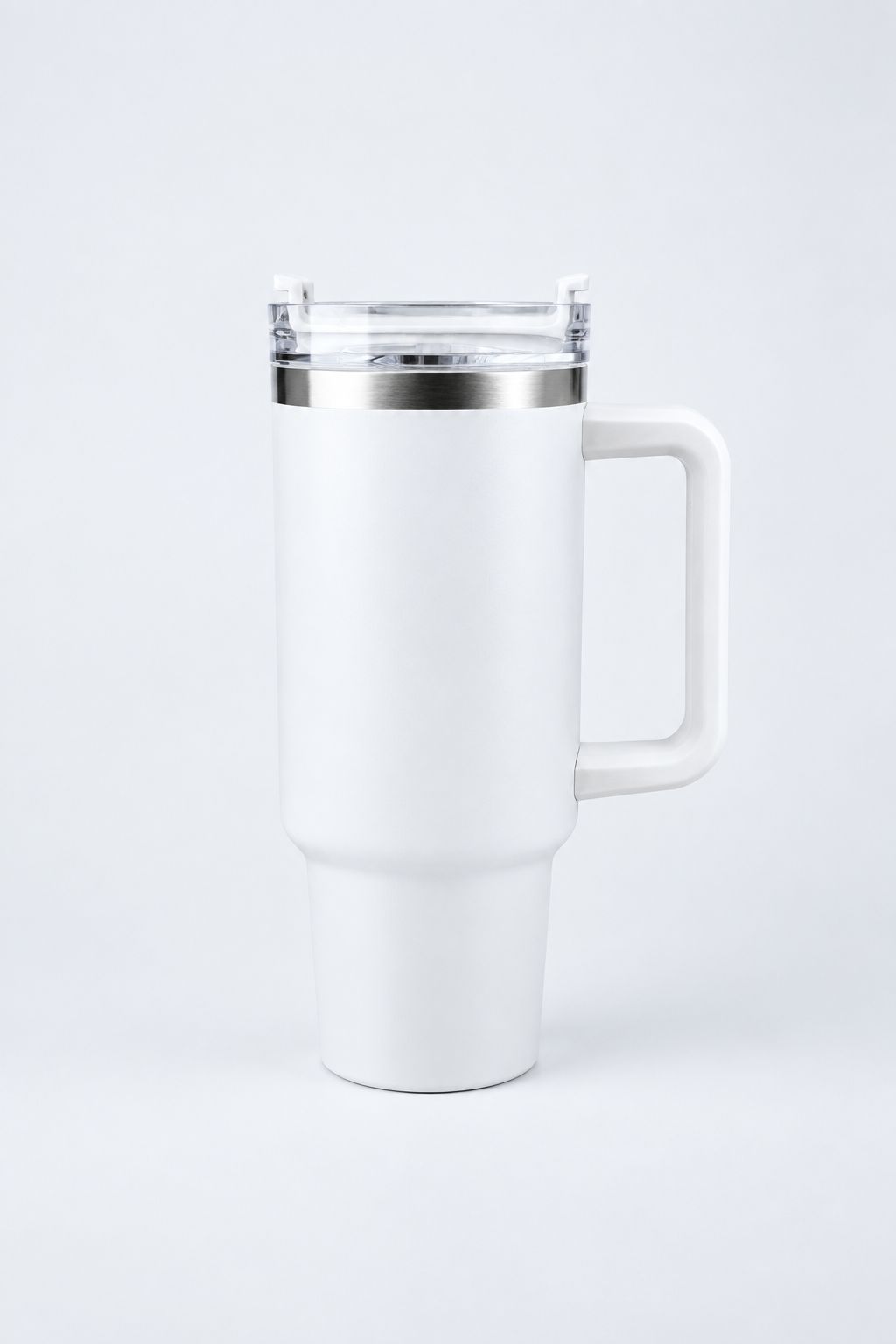 White handled tumbler on a pale studio tabletop